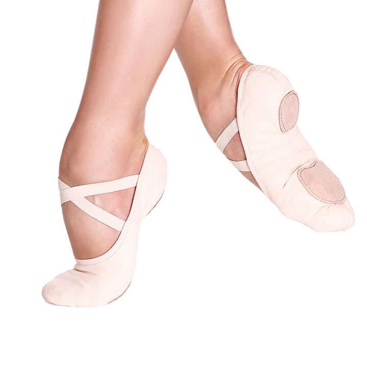Ballet shoes worn on a white background