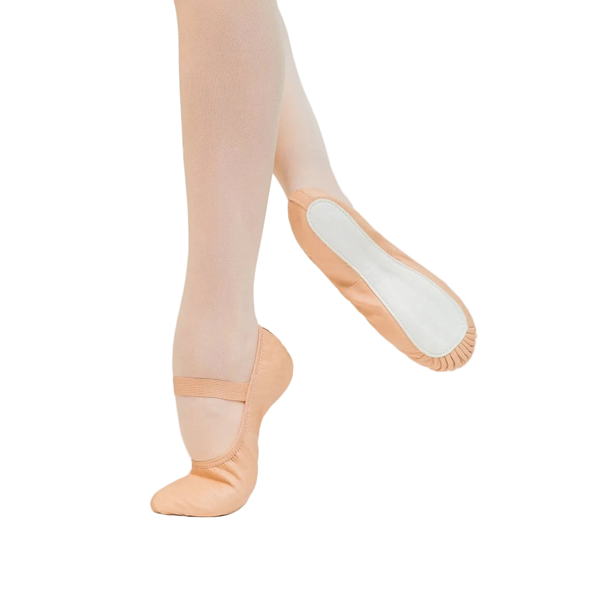 A pair of peach-colored fabric ballet slippers shown on a dancer's feet, with one shoe on the tip of the toe and the other angled to show the white padded footbed.