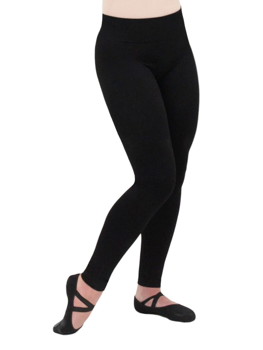 Person wearing black leggings and ballet shoes on a white background
